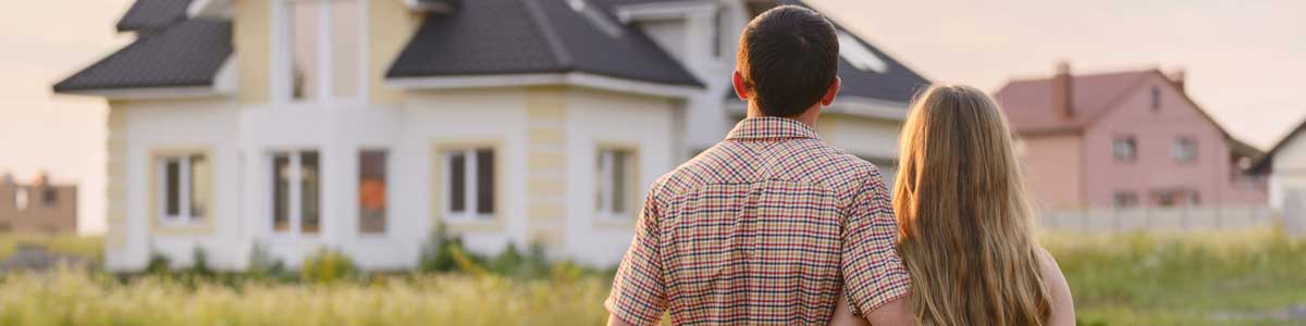 Couple in Front of a House